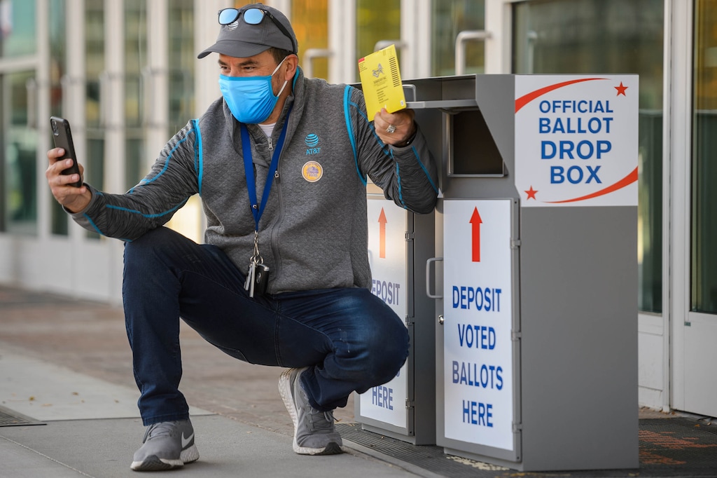 (Trent Nelson  |  The Salt Lake Tribune) Jaime Ortega films a video as he puts his ballot in a drop box at Vivint Smart Home Arena in Salt Lake City on election day, Tuesday, Nov. 3, 2020.