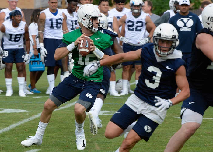 (Francisco Kjolseth  |  The Salt Lake Tribune)  BYU quarterback Tanner Mangum runs through drills as the team opens preseason training camp on their practice field on Thursday, Aug. 2, 2018.