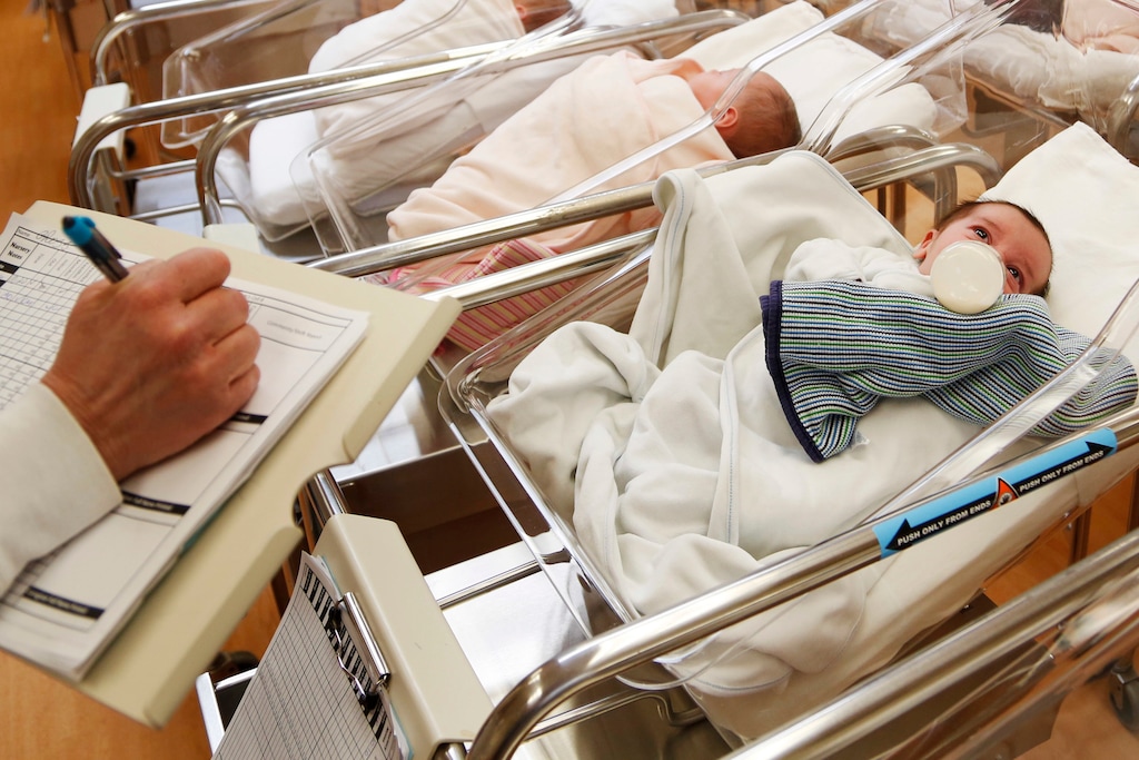 FILE - This Feb. 16, 2017 file photo shows newborn babies in the nursery of a postpartum recovery center in upstate New York. Women in the United States gave birth last year at the lowest rate in three decades, a trend that could weigh on economic growth in future decades. The number of babies born in the U.S. has fallen for three straight years, and as births decline and the population ages, fewer Americans are available to work or start businesses, thereby slowing the economy. (AP Photo/Seth Wenig, File)