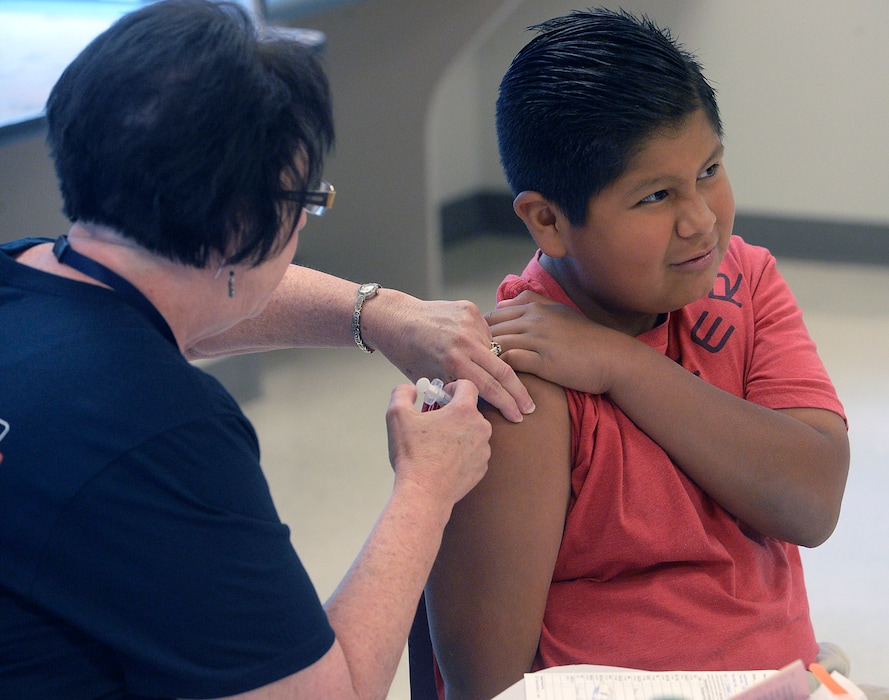 (Al Hartmann  |  Tribune photo file)  Alexis Herrera, 11, gets an immunization shot for school at the Junior League CARE Fair in the Horizonte Center in Salt Lake City Friday July 15, 2016. At the request of Utah lawmakers, the state Department of Health said on Monday it will alter the wording on personal-exemption forms for parents opting out of vaccinating their kids, to free them from having to acknowledge the health risks.