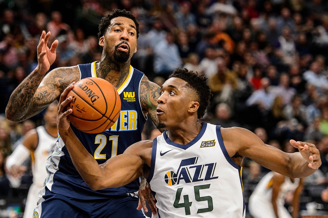 (Trent Nelson | The Salt Lake Tribune)  Utah Jazz guard Donovan Mitchell (45) drives on Denver Nuggets forward Wilson Chandler (21) as the Utah Jazz host the Denver Nuggets, NBA basketball in Salt Lake City, Wednesday October 18, 2017.