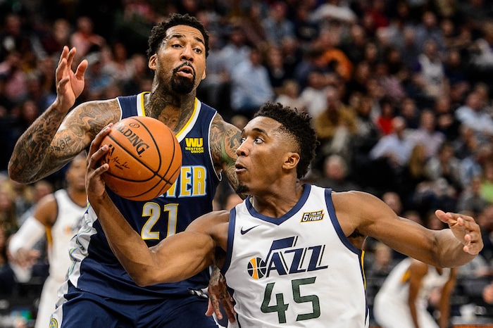 (Trent Nelson | The Salt Lake Tribune)  Utah Jazz guard Donovan Mitchell (45) drives on Denver Nuggets forward Wilson Chandler (21) as the Utah Jazz host the Denver Nuggets, NBA basketball in Salt Lake City, Wednesday October 18, 2017.