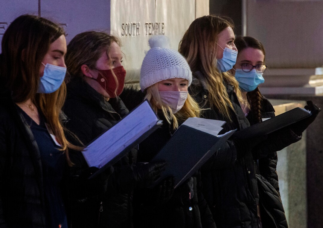 (Rick Egan | The Salt Lake Tribune)  Temple Square is closed, but sister missionaries sing Christmas carols in front of the Joseph Smith Memorial Building, in downtown Salt Lake City, Friday, Nov. 27, 2020.
