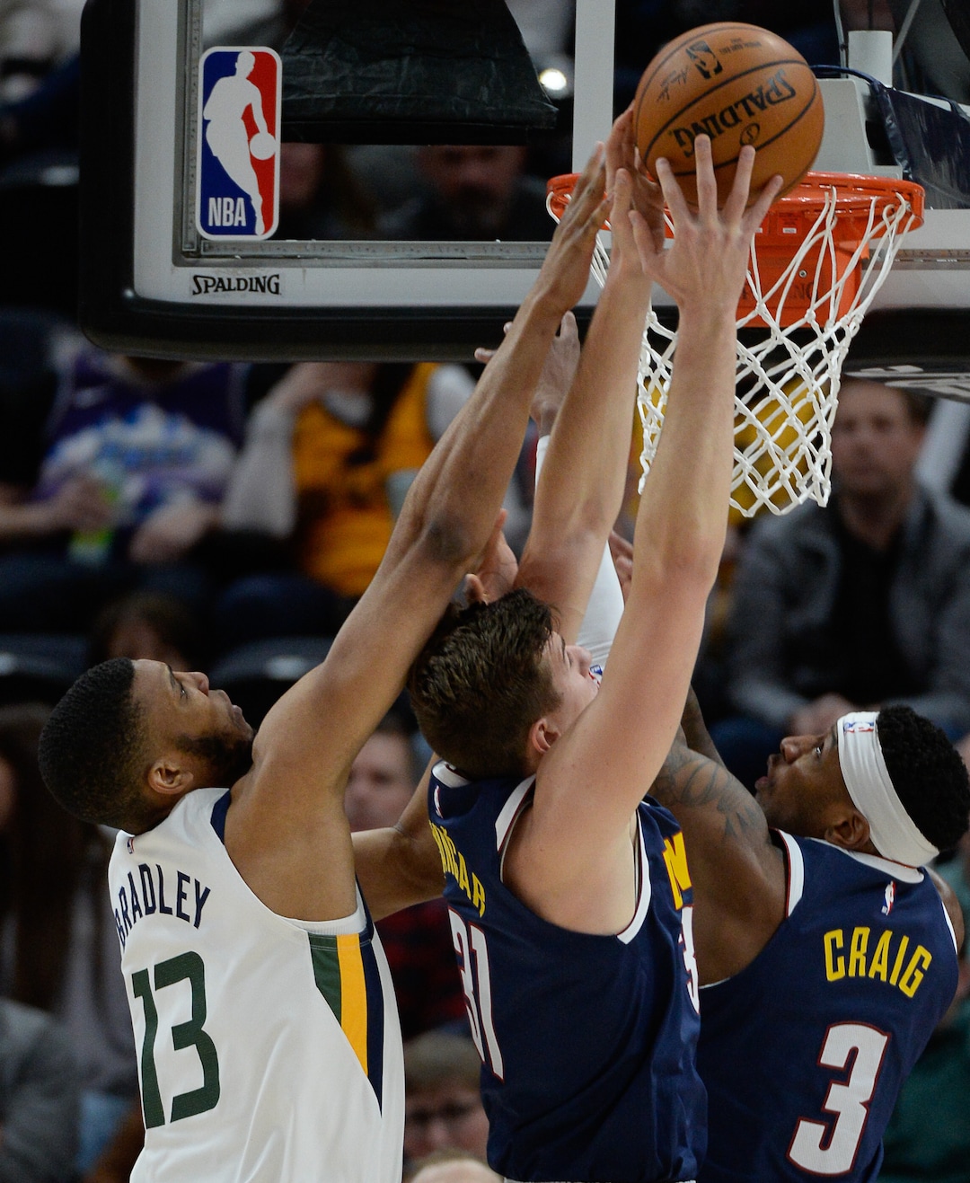 (Francisco Kjolseth  |  The Salt Lake Tribune) Utah Jazz center Tony Bradley (13) tries to get a basket past Denver Nuggets forward Vlatko Cancar (31) and Denver Nuggets forward Torrey Craig (3) as the Utah Jazz host the Denver Nuggets in their NBA basketball game at Vivint Smart Home Arena in Salt Lake City on Wednesday, Feb. 5, 2020.