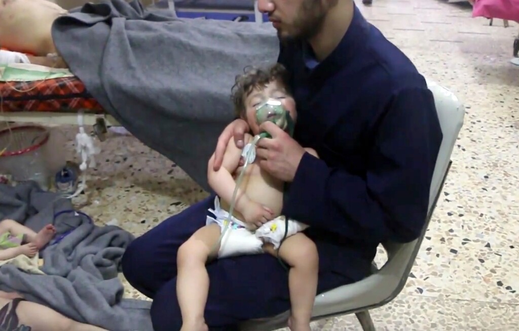 (Syrian Civil Defense White Helmets | The Associated Press) This image made from video released by the Syrian Civil Defense White Helmets, which has been authenticated based on its contents and other AP reporting, shows a medical worker giving toddlers oxygen through respirators following an alleged poison gas attack in the opposition-held town of Douma, in eastern Ghouta, near Damascus, Syria, Sunday, April 8, 2018. Syrian opposition activists and rescuers said Sunday that a poison gas attack on a rebel-held town near the capital. The Syrian government denied the allegations, which could not be independently verified.