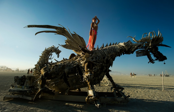 (Rick Egan  |  The Salt Lake Tribune)Anya from Russia, stands on Claude The Dragon, by Tasha Zanotto, in the Black Rock Desert, during Burning Man 2017, Saturday, September 2, 2017.