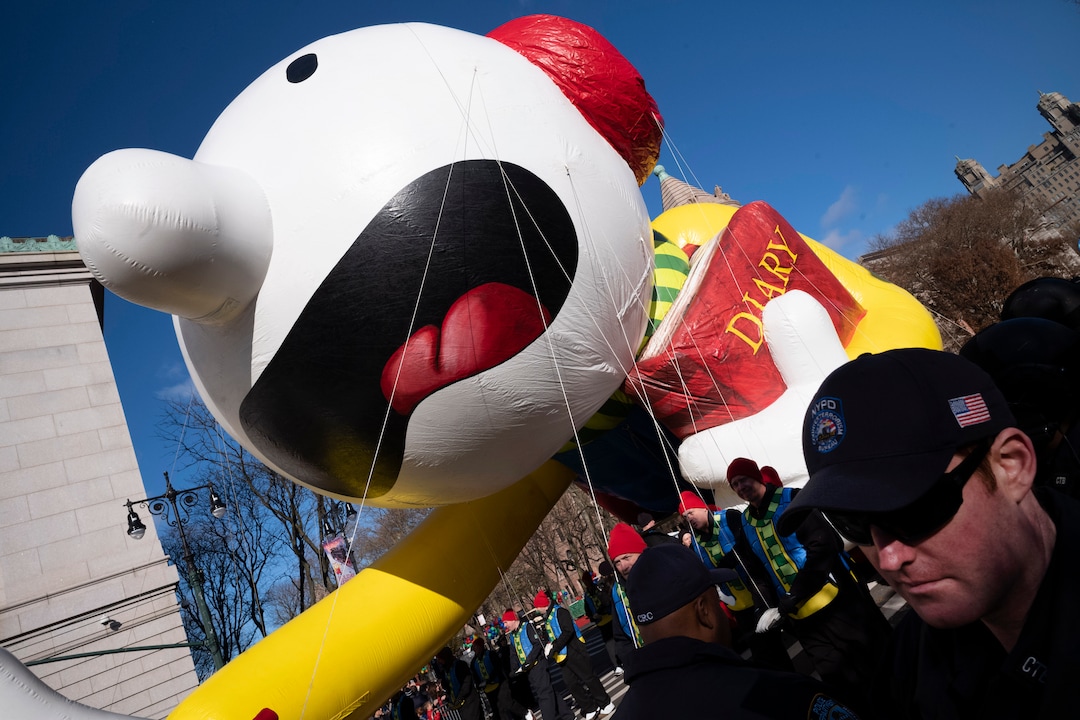 (Mark Lennihan | AP)  Balloon handlers hold Diary of a Wimpy Kid balloon close to the ground as strong winds affect the Macy's Thanksgiving Day Parade, Thursday, Nov. 28, 2019, in New York.