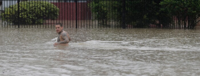 (David J. Phillip | The Associated Press) A man wades through floodwaters from Tropical Storm Harvey Sunday, Aug. 27, 2017, in Houston, Texas.