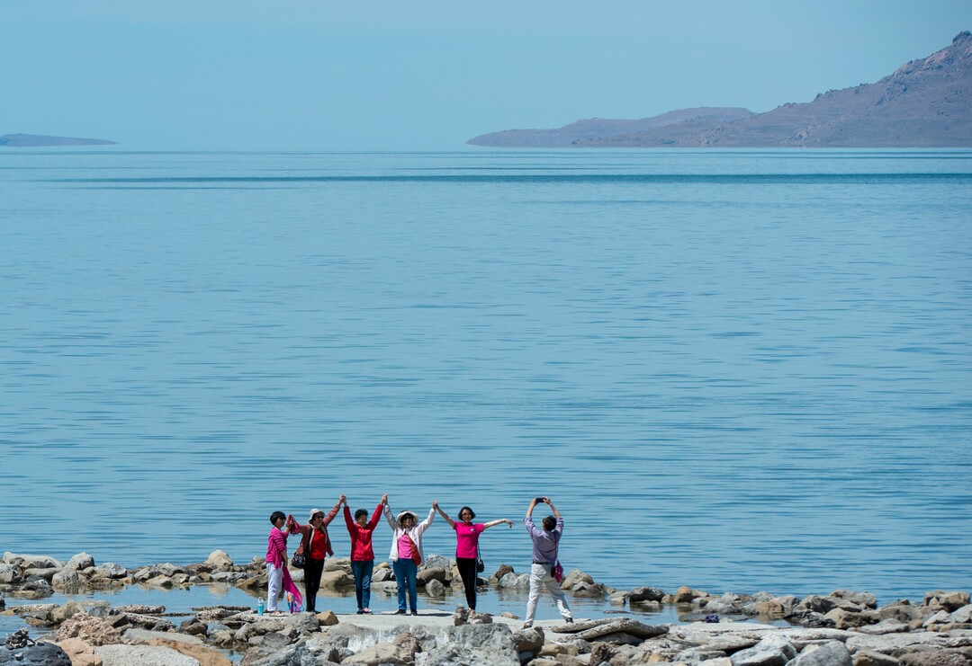 (Rick Egan  |  The Salt Lake Tribune)     Tourists pose for a photo on the shore of the Great Salt Lake, Tuesday, June 11, 2019.