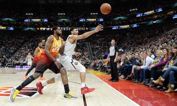 (Francisco Kjolseth  |  The Salt Lake Tribune)  Utah Jazz forward Royce O'Neale (23) chases a ball down with Denver Nuggets guard Jamal Murray (27) ending up in the stands as the Utah Jazz host the Denver Nuggets in their NBA game at Vivint Smart Home Arena Tuesday, April 9, 2019, in Salt Lake City.