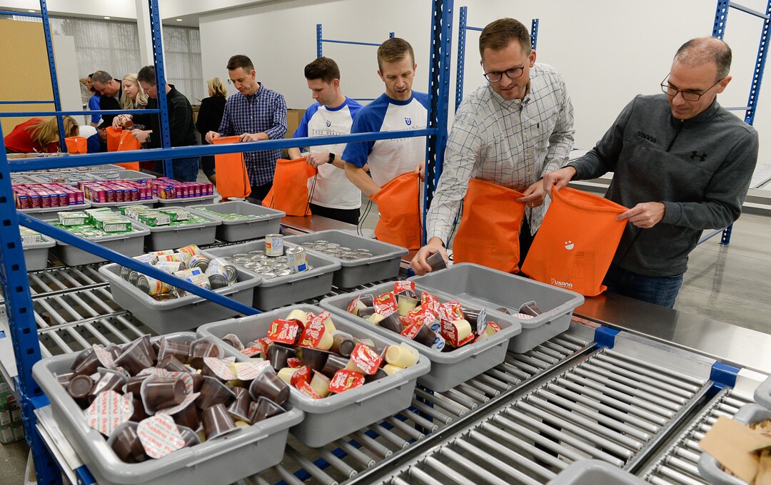 (Francisco Kjolseth  |  The Salt Lake Tribune)  USANA staff volunteer their time assembling food bags for at-risk youth at the newly-renovated packing and storage facility next to the headquarters of the Salt Lake City company on Wed. Dec. 11, 2019. The USANA Foundation has acquired two local charities, Kids Next Door and KidsEat!, that provides hundreds of food bags every week for the kids for the weekends and during long school breaks.