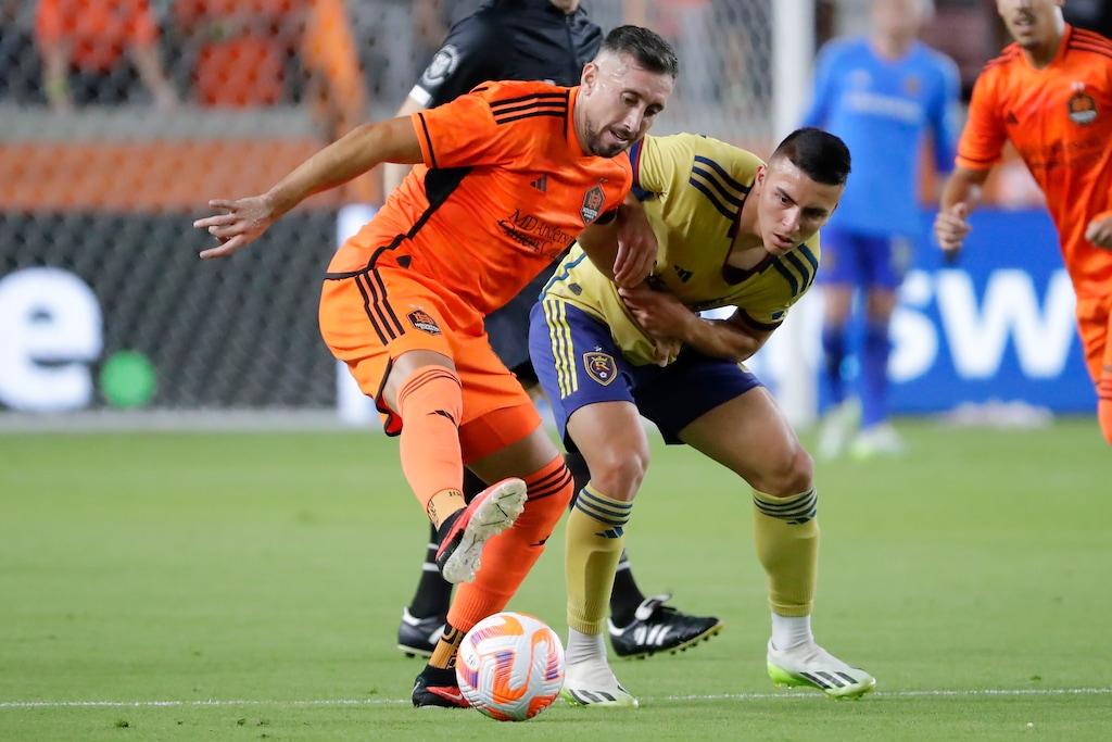 (Michael Wyke | AP) Houston Dynamo midfielder Hector Herrera, left, blocks out Real Salt Lake midfielder Braian Ojeda, right, as Herrera looks to pass the ball during the first half of a U.S. Open Cup soccer semifinal soccer match, Wednesday, Aug. 23, 2023, in Houston.