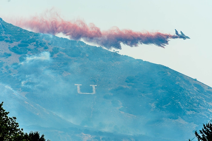 (Trent Nelson | The Salt Lake Tribune)  A tanker drops fire retardant in Uintah at the mouth of Weber Canyon, Tuesday September 5, 2017.