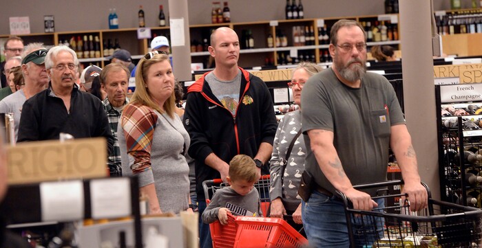 People wait in long check out lines at the Cottonwood Heights, Utah, state liquor store on Wednesday, Nov. 22, 2017. (Al Hartmann/The Salt Lake Tribune via AP)