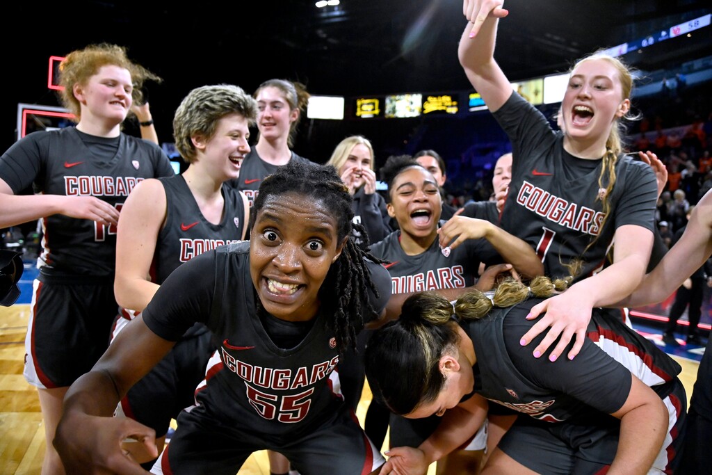 (David Becker | AP) Washington State center Bella Murekatete, front, celebrates with teammates after a victory over Utah in an NCAA college basketball game in the quarterfinals of the Pac-12 women's tournament Thursday, March 2, 2023, in Las Vegas.