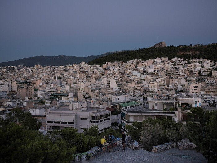 (Myrto Papadopoulos | The New York Times) Hasib Hotak, a homeless refugee from Afghanistan, and friends pass an evening in a park in Athens, Greece, July 22, 2020. Around the world, the poor and marginalized are much more likely to be vulnerable to extreme heat; Hasib has been sleeping on a rooftop that turns blazing hot by midday.