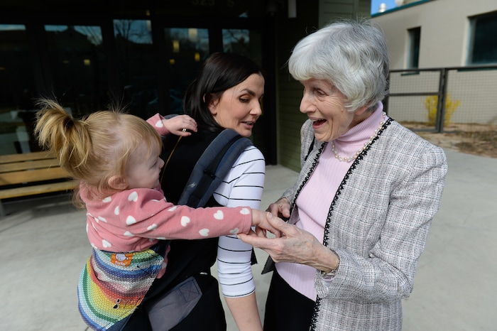 (Francisco Kjolseth | The Salt Lake Tribune) Eva May Densley, 1, carried by her mother Michelle, calls out "grandma" after catching a glimpse of champion for the homeless Pamela Atkinson while touring the YWCA Center for Women & Familes in Salt Lake on Tuesday, March 20, 2018. Michelle, a mother of three who lived out of her car and peoples homes for a time feels blessed to have landed an apartment at the women's center after experiencing violent abuse from her former husband during her pregnancy with Eva. Atkinson is encouraging people to donate to the Pamela Atkinson Homeless Trust Fund through their tax forms.