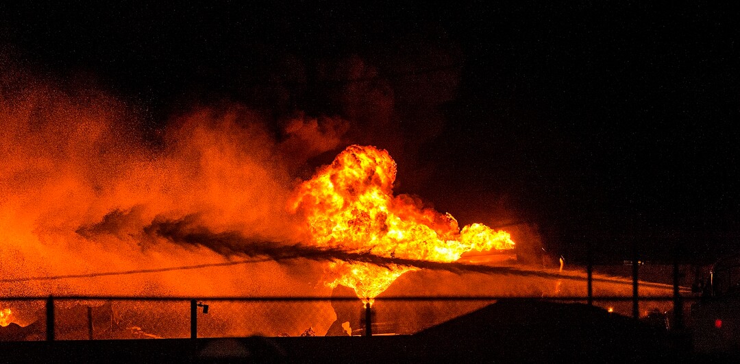 (Chris Detrick  |  The Salt Lake Tribune)  Firefighters attempt to put out a burning semitrailer that was hauling thousands of gallons of fuel on Interstate-15 in Midvale Thursday, January 18, 2018.   Lt. Todd Royce of the Utah Highway Patrol said the truck was southbound on the interstate at 7500 South at 7:20 p.m. when a tire caught fire, sending flames toward the tanks.