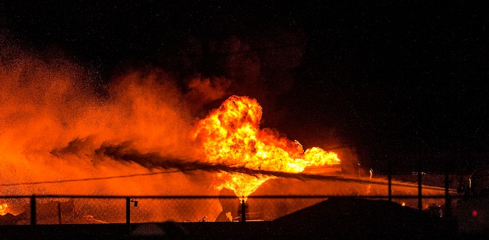 (Chris Detrick  |  The Salt Lake Tribune)  Firefighters attempt to put out a burning semitrailer that was hauling thousands of gallons of fuel on Interstate-15 in Midvale Thursday, January 18, 2018.   Lt. Todd Royce of the Utah Highway Patrol said the truck was southbound on the interstate at 7500 South at 7:20 p.m. when a tire caught fire, sending flames toward the tanks.