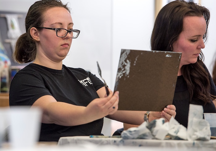 (Leah Hogsten  |  The Salt Lake Tribune)  Kali Wickens, left, sizes up the progression of her painted winter scene in the  Bob Ross Paint-Along class, Saturday, Jan. 6, 2018, at the Salt Lake City Public Library's Sweet Branch in the Avenues.