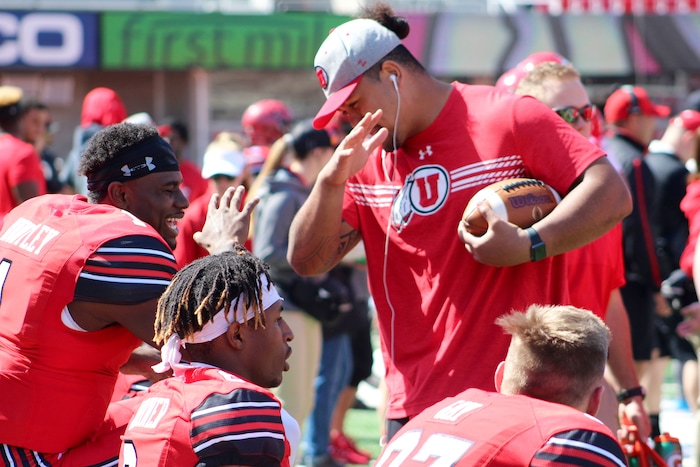 (Christopher Kamrani | The Salt Lake Tribune) Utah quarterback Tyler Huntley (1) and center Lo Falemaka (right) dance on the sidelines during Utah's Red-White game Saturday afternoon at Rice-Eccles Stadium.