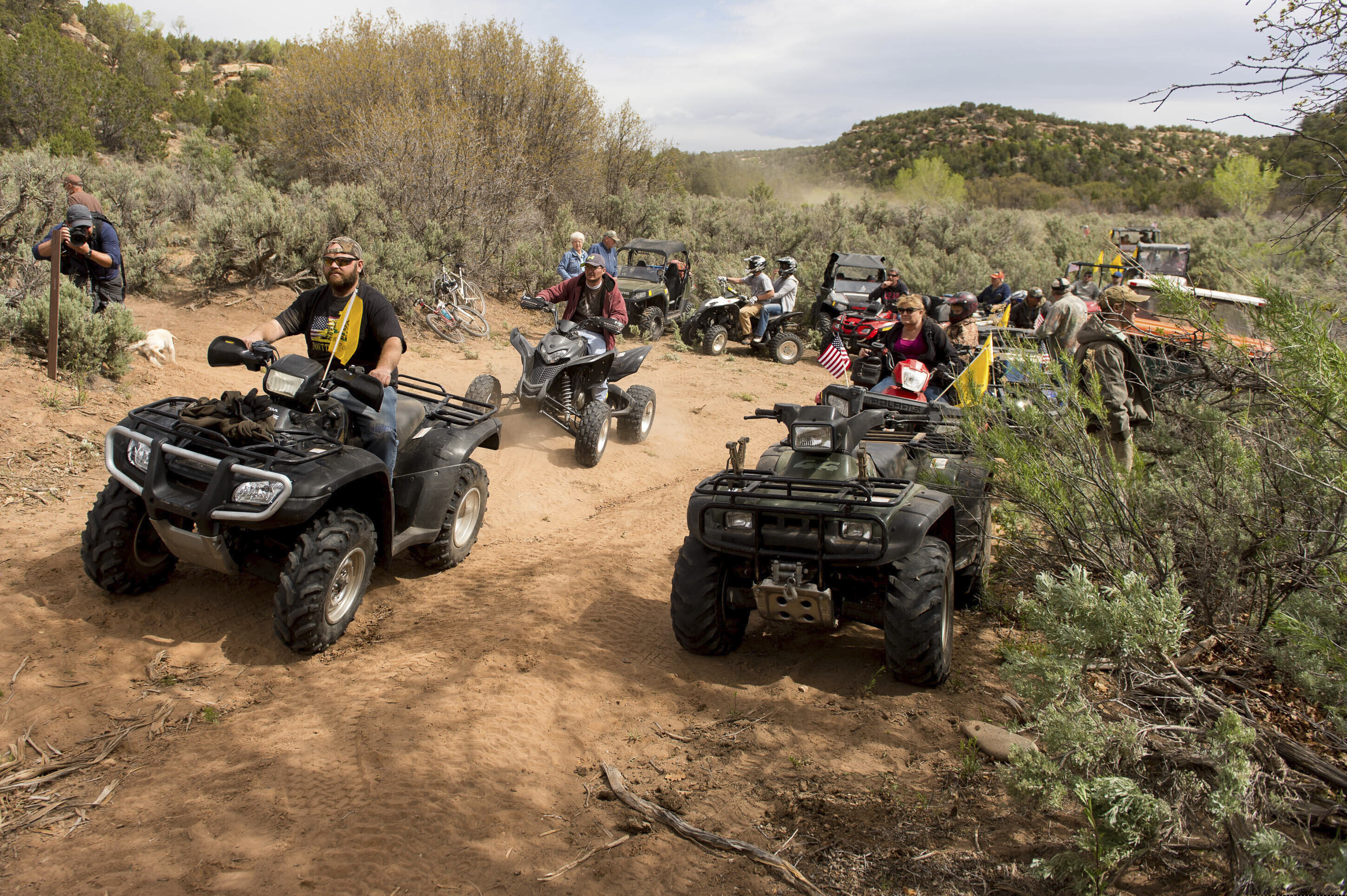 FILE - In this May 10, 2014, file photo, people ride ATV's into Recapture Canyon east of Blanding, Utah, in a protest against what demonstrators call the federal government's overreaching control of public lands. San Juan County has spent more than $400,000 on outside lawyers building a case that it owns a three-mile road segment through the canyon. Now the county wants the state to cover some of the bills. (Trent Nelson/The Salt Lake Tribune via AP, File)
