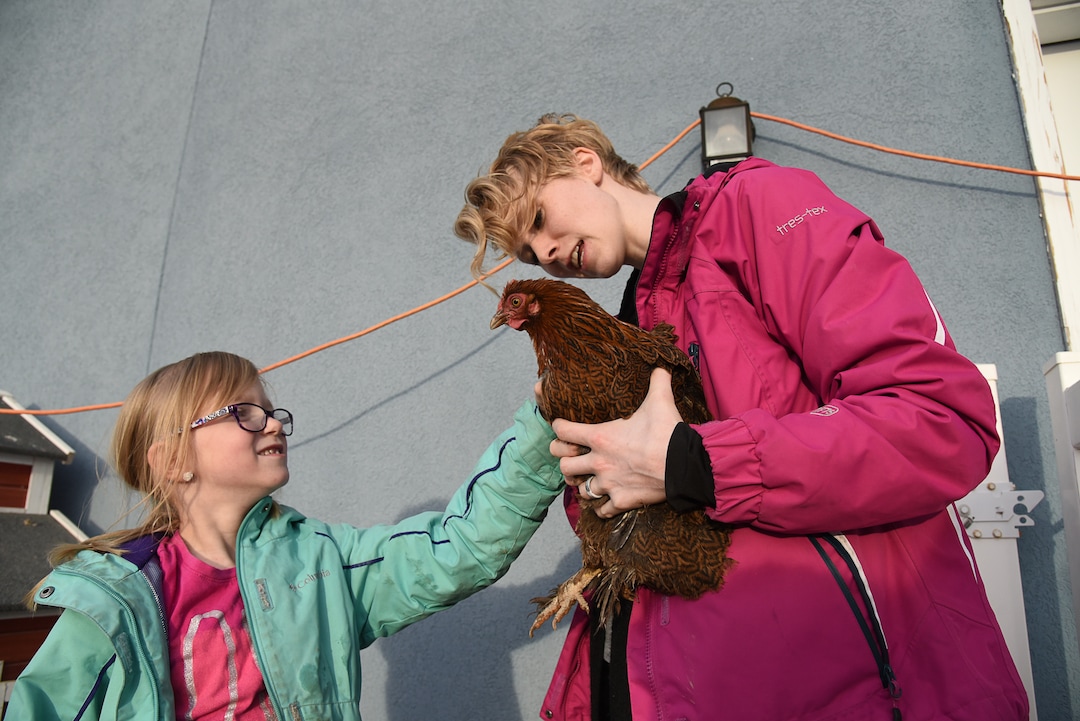 (Francisco Kjolseth  |  The Salt Lake Tribune)  Skyrie Sacks, 7, pets Poliwag, held by her mother, Natalie, as they visit the backyard coop where all eight of their chickens are named after Pokémon characters. Natalie Sacks says emotional support chickens have helped her daughter  deal with PTSD from a traumatic accident that happened when she was 4. But the Sacks family had to move from their home in Herriman because of an HOA dispute over the chickens that made them feel threatened and scared.