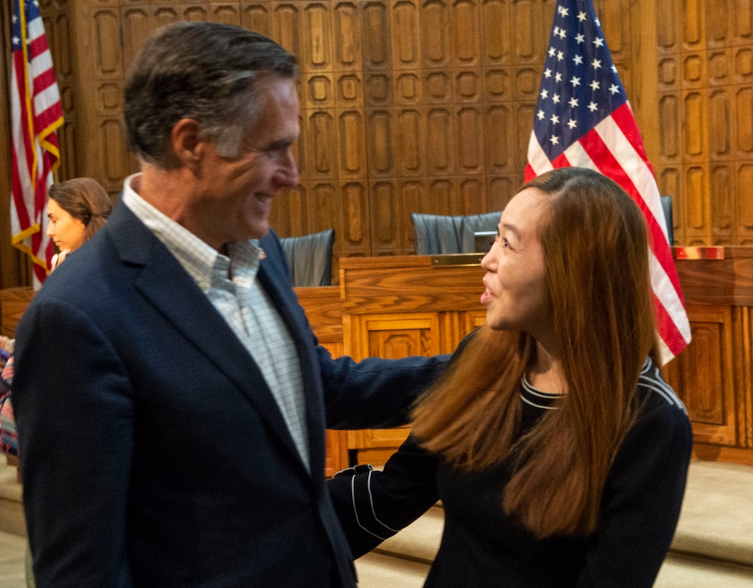 (Rick Egan  |  The Salt Lake Tribune)       Mitt Romney visits with Lucia Kou, after the town hall meeting in the Provo City Hall Council Chambers, Friday, June 21, 2019.
