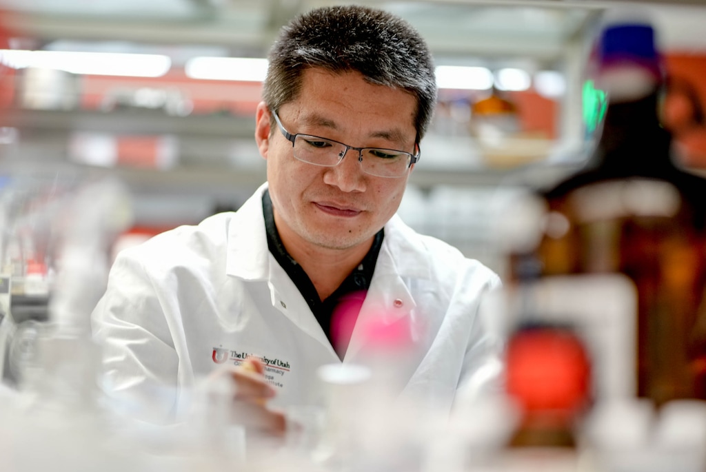 (Francisco Kjolseth | The Salt Lake Tribune) Researcher Zhenjian Lin works in his lab at the University of Utah on Thursday, June 9, 2022, where he and other researchers found a way to produce a potential anti-cancer compound found in coral. The researcher has had some of his work funded by the National Institutes of Health, but a 2025 directive from the Trump administration could reduce how much money schools get to cover research expenses.