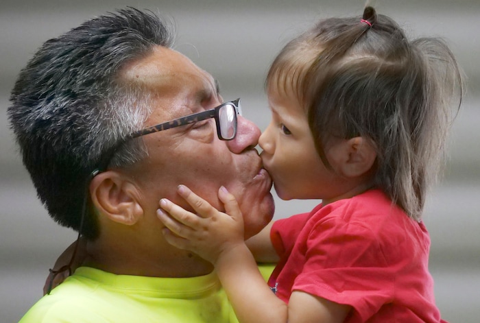 Romulo Gonzalez Rodriguez and his 3-year-old daughter Genesis kiss before a interview Tuesday, June 19, 2018, in Provo, Utah. Gonzalez Rodriguez spoke about the anguish of being separated from his 3-year-old daughter, Genesis Gonzalez Lopez, for seven days in November after arriving to the U.S. port of entry in San Diego. Gonzalez Rodriguez said he fled his hometown of Champerico, Guatemala to seek asylum in the United States after he was kidnapped and extorted by captors who cut his eye out and nearly killed him. (AP Photo/Rick Bowmer)