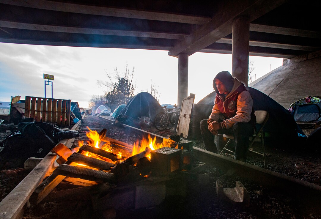 (Rick Egan | The Salt Lake Tribune)  The abandoned railroad tracks create a space for a fire pit under the freeway at Camp Last Hope on Friday, Jan. 1, 2021.