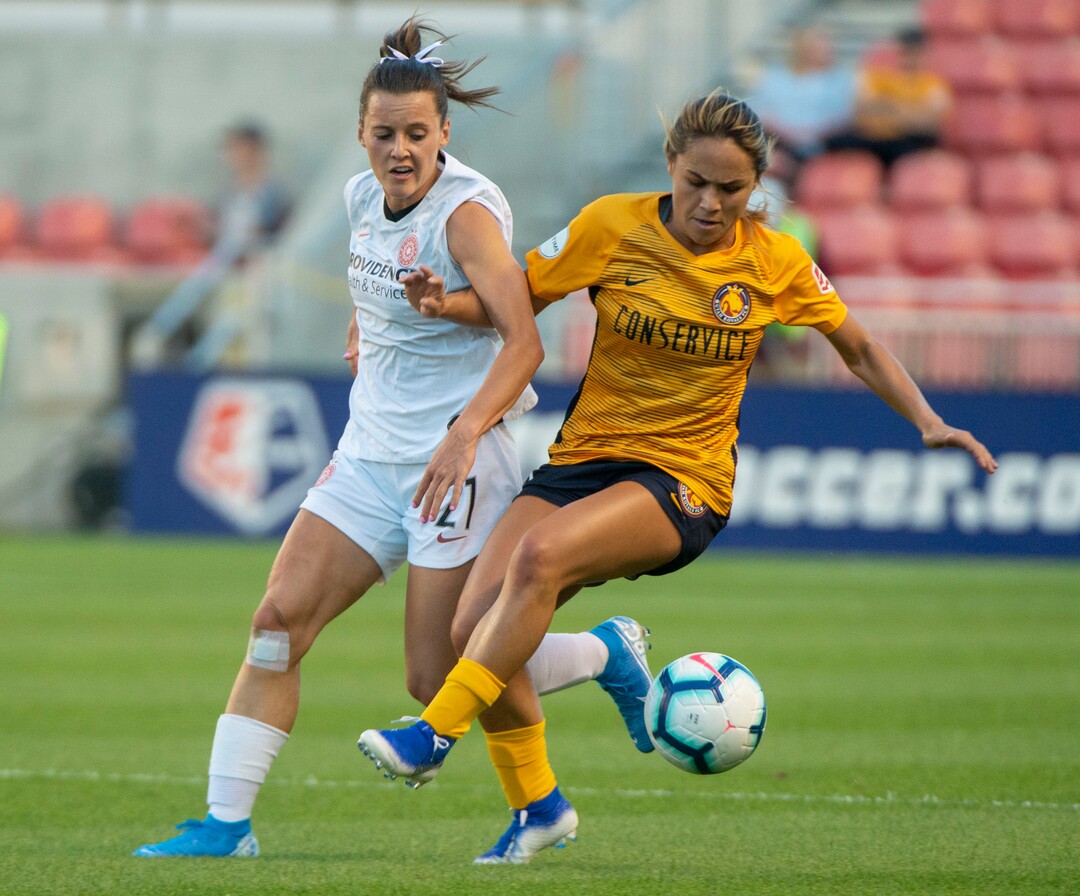 (Rick Egan  |  The Salt Lake Tribune)    Utah Royals FC midfielder Lo'eau LaBonta (9) goes for the ball along with Portland Thorns FC defender Elizabeth Ball (27), in Soccer action between Utah Royals FC and Portland Thorns FC, in Sandy, Friday, July 19, 2019.