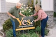 (Tamara Kenyon for The 19th) Steve and Lisa Wirsching place a sign supporting Proposition 1 in the yard of their home in Meridian, Idaho, on October 5, 2026.