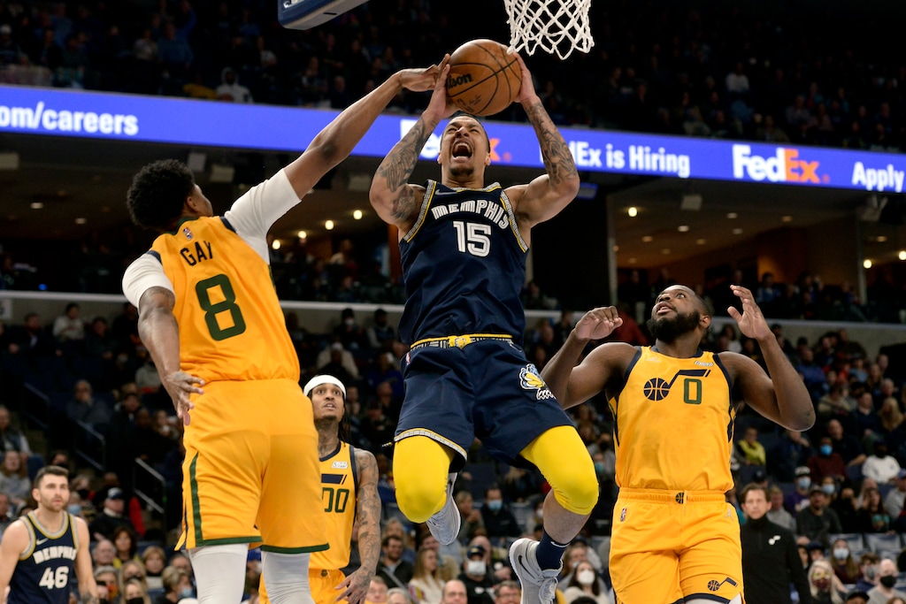 Memphis Grizzlies forward Brandon Clarke (15) jumps to shoot against Utah Jazz forward Rudy Gay (8) as forward Eric Paschall (0) moves for position in the first half of an NBA basketball game Friday, Jan. 28, 2022, in Memphis, Tenn. (AP Photo/Brandon Dill)