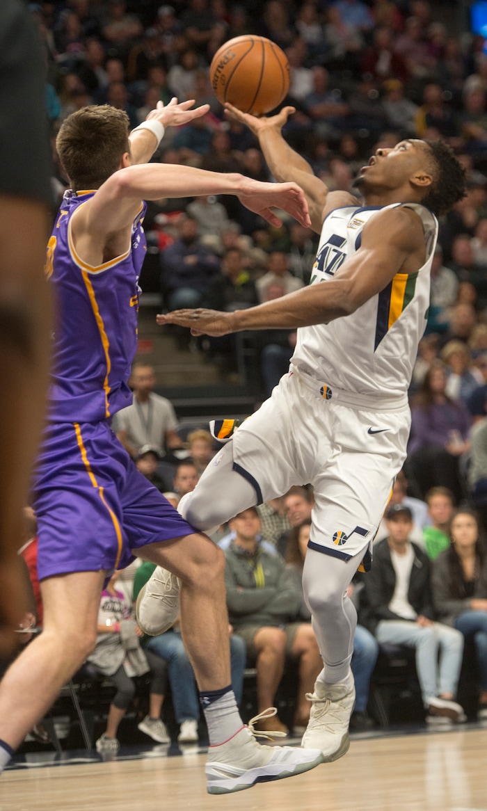 (Rick Egan  |  The Salt Lake Tribune)  Utah Jazz guard Donovan Mitchell (45) goes up for a shot, as Sydney Kings forward Dane Pineau (22) defends, in preseason basketball Utah Jazz vs.Sydney Kings, in Salt Lake City, Sunday, October 2, 2017.


