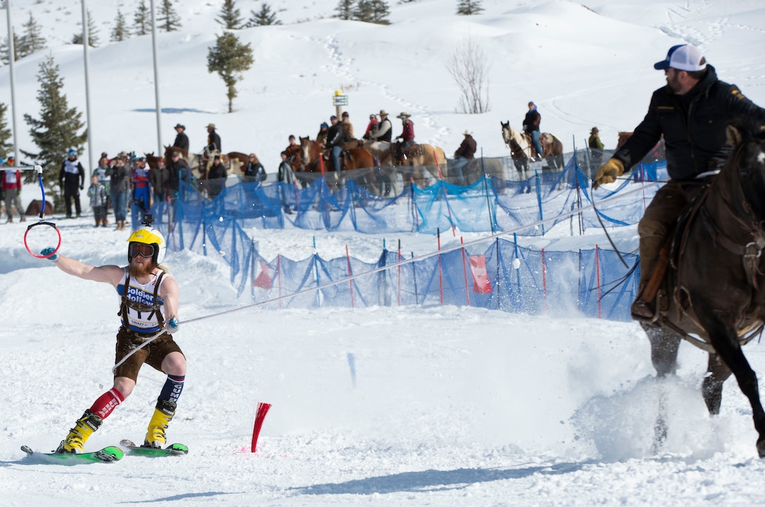 (Rick Egan  |  The Salt Lake Tribune)   Caden Spencer is pulled by Jake Ream, riding Cadillac the horse, for the team "Snow Choppers", in the first day of the Skijoring competition at Soldier Hollow Friday.  Feb. 22, 2019.  The competition continues on Saturday.