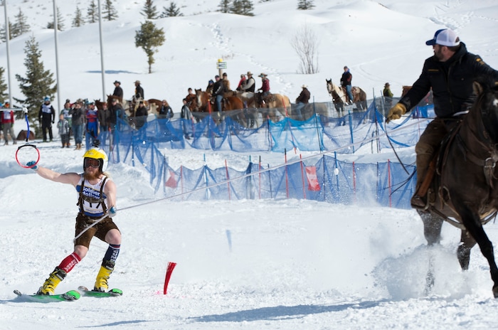 (Rick Egan | The Salt Lake Tribune) Caden Spencer is pulled by Jake Ream, riding Cadillac the horse, for the team "Snow Choppers", in the first day of the Skijoring competition at Soldier Hollow Friday. Feb. 22, 2019. The competition continues on Saturday.