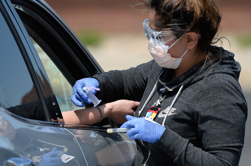 (Francisco Kjolseth | The Salt Lake Tribune) Phlebotomist Adriana Rodriguez performs a blood draw to test for coronavirus antibodies in Park City on Wednesday, May 6, 2020, as part of the Utah HERO (Health & Economic Recovery Outreach) program. The massive undertaking will begin with randomized testing of 10,000 Utahns across four counties. The data gathered will inform decision-makers in the state as they work to help keep residents safe and get people back to work.