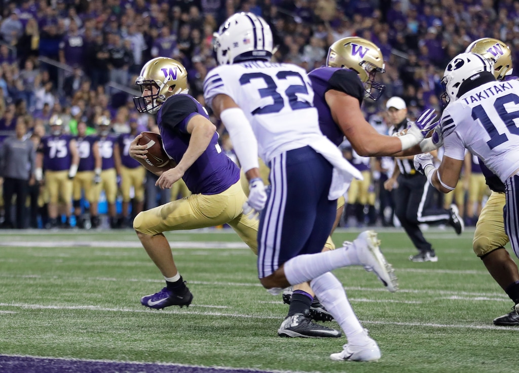 Washington quarterback Jake Browning, left, scrambles for a touchdown during the first half of an NCAA college football game against Brigham Young, Saturday, Sept. 29, 2018, in Seattle. (AP Photo/Ted S. Warren)