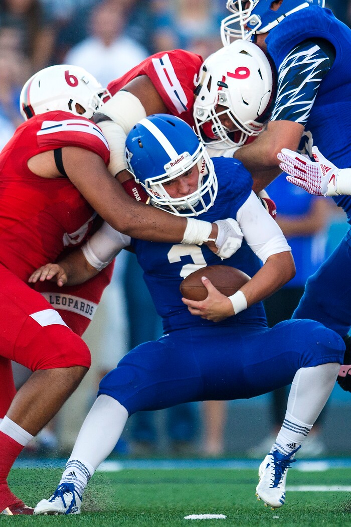 (Chris Detrick  |  The Salt Lake Tribune)  East's Johnson Hansen (6) and East's Tennessee Pututau (9) sack Bingham's Ryan Wood (2) during the game at Bingham High School Friday, August 25, 2017. Bingham is winning the game 24-17 at halftime. 