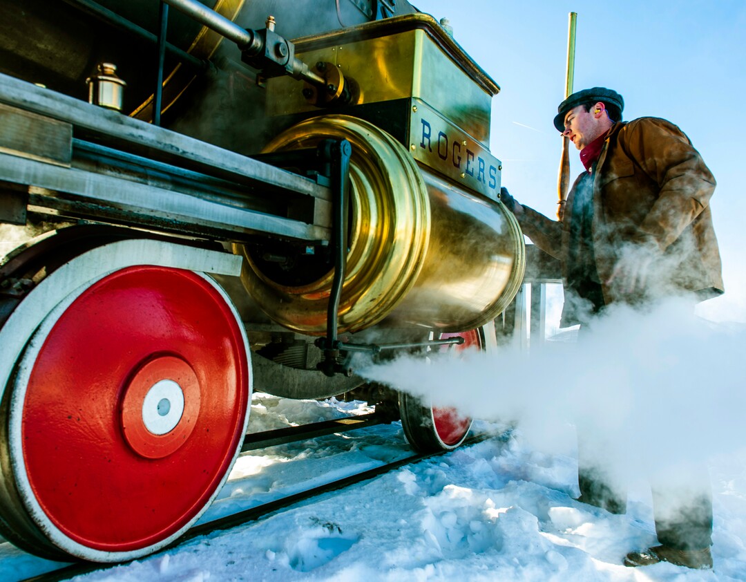 (Rick Egan | The Salt Lake Tribune) Volunteer fireman, Jace Evans, polishes the 119 Steam Engine between runs, at the Golden Spike National Historical Park, on Tuesday, Dec. 29, 2020.