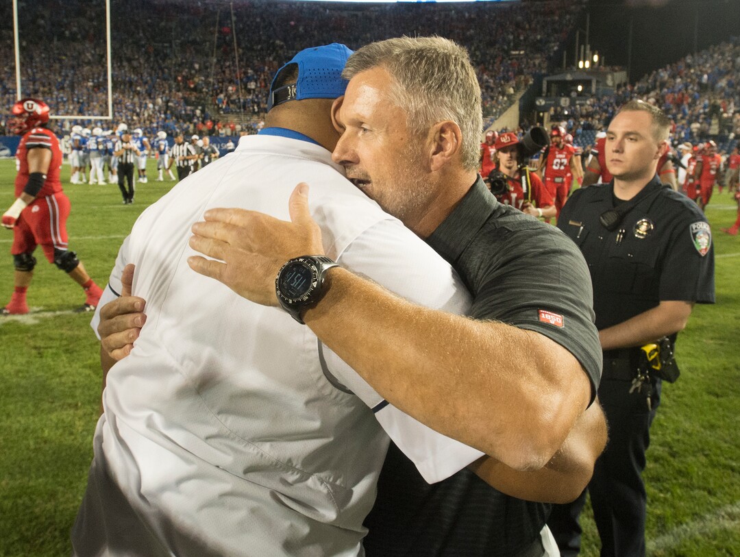 (Rick Egan  |  The Salt Lake Tribune)  Brigham Young Cougars head coach Kalani Satike hugs Utah head coach Kyle Whittingham after BYU was defeated by Utah, 19-13, at Lavell Edwards Stadium in Provo, Saturday, September 9, 2017.