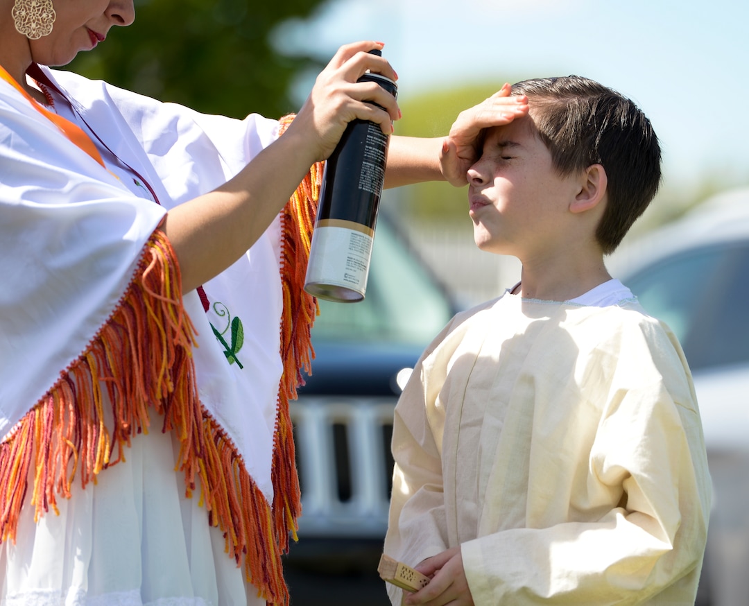 (Leah Hogsten  |  The Salt Lake Tribune) Bastian Sellers, 10, gets his hair tacked down with hair spray by his mother Mabel Sellers before the two dancers perform at the Cinco de Mayo Celebration, Saturday, May 5, 2018 at Centennial Park in West Valley City.