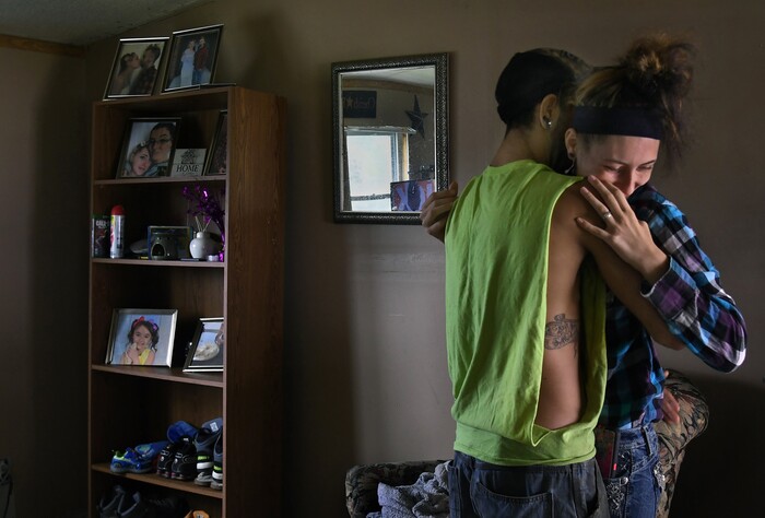 (Washington Post photo by Michael S. Williamson) Maria gives a goodbye hug to her husband Phil before he heads off to work.