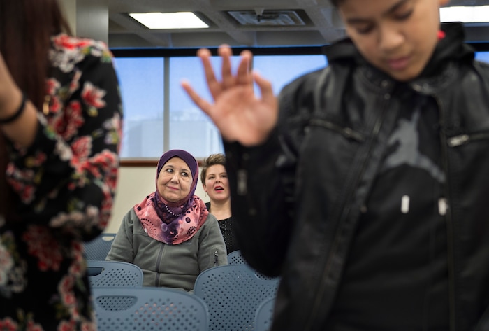 (Scott Sommerdorf   |  The Salt Lake Tribune)   Layla Hussein, the aunt of Haitham Layth Mohammed Ali watches as he, right, takes the pledge and becomes a U.S. citizen during a ceremony in recognition of children who have obtained citizenship through their parents, Thursday, December 28, 2017. Hussein escaped Baghdad in 2002 and her family followed soon after.