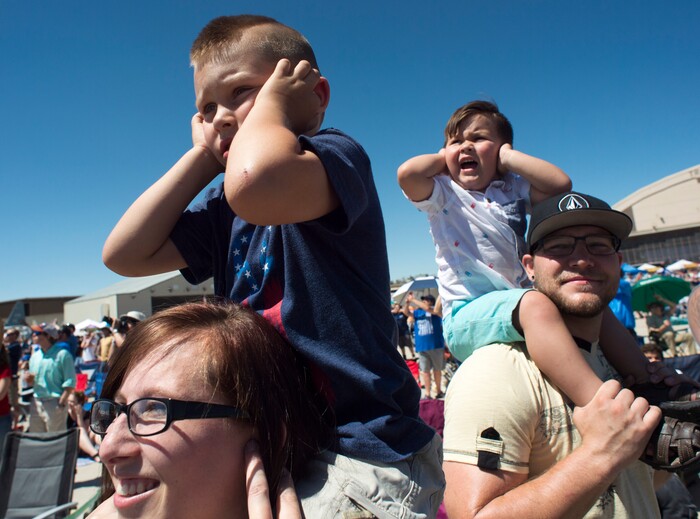 (Rick Egan  |  The Salt Lake Tribune)   Brittine Balls holds her son, Ryker, 5, and Jesse Balls holds his son Brixton, 3, as the F-35A jets fly overhead, during the Warriors Over the Wasatch airshow at Hill Airforce Base, Sunday, June 24, 2018.