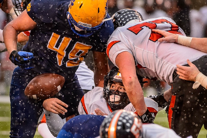 (Trent Nelson | The Salt Lake Tribune)  Mountain Crest's Brady Hall (1) watches the ball fall out of his hands with Orem's William Tenney (49) standing over him as Orem faces Mountain Crest in the Class 4A High School State Football Championship game in Salt Lake City, Friday November 17, 2017.