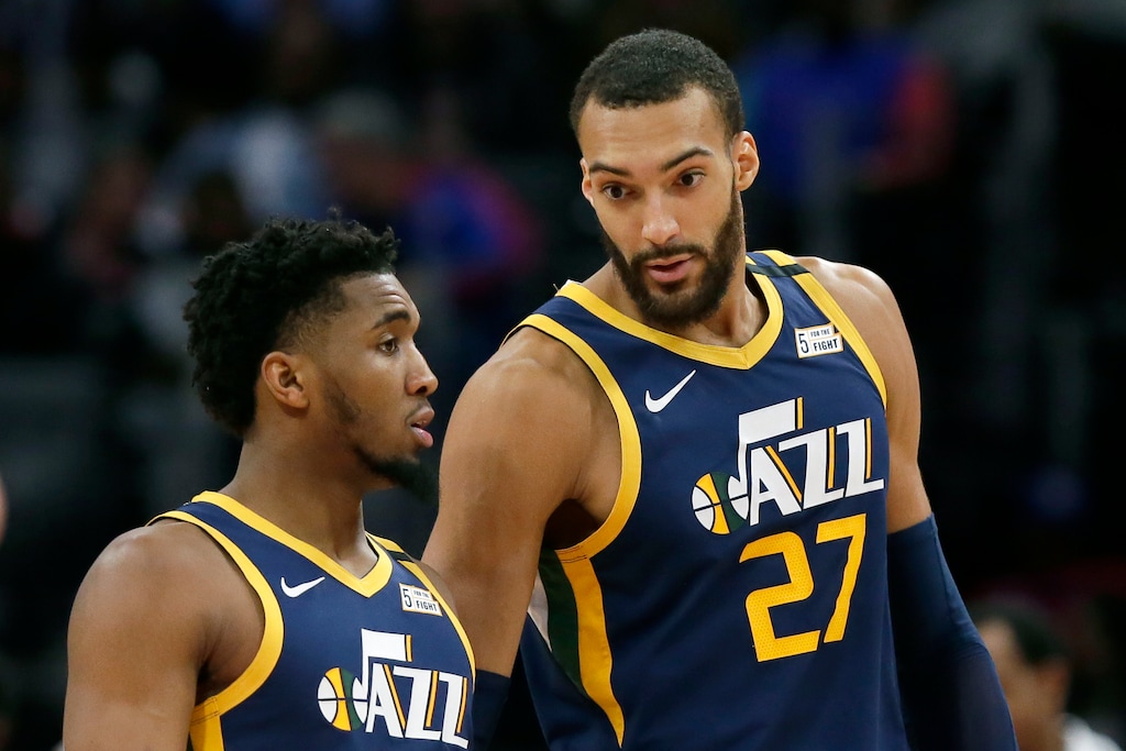 FILE - In this Saturday, March 7, 2020, file photo, Utah Jazz center Rudy Gobert (27) talks with guard Donovan Mitchell, left, during the second half of an NBA basketball game against the Detroit Pistons, in Detroit. Both players have tested positive for the coronavirus. Gobert's test result forced the NBA to suspend the season. (AP Photo/Duane Burleson, File)