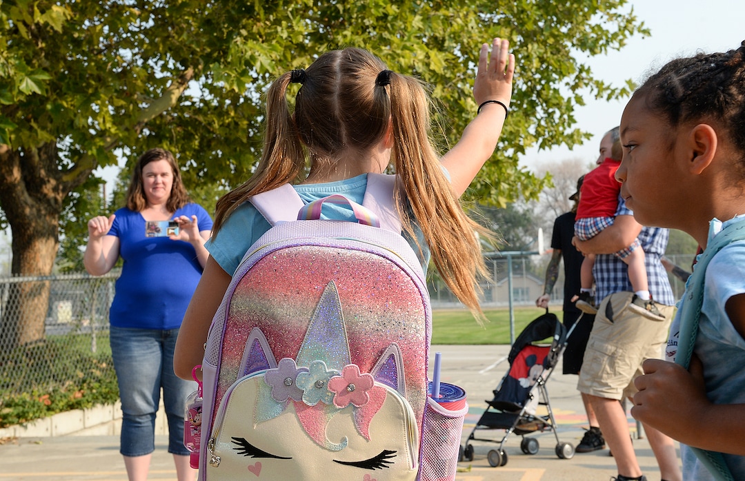 (Chris Samuels | The Salt Lake Tribune) Parents and wave goodbye before the first day of school at Whittier Elementary in West Valley City, Monday, Aug. 16, 2021.
