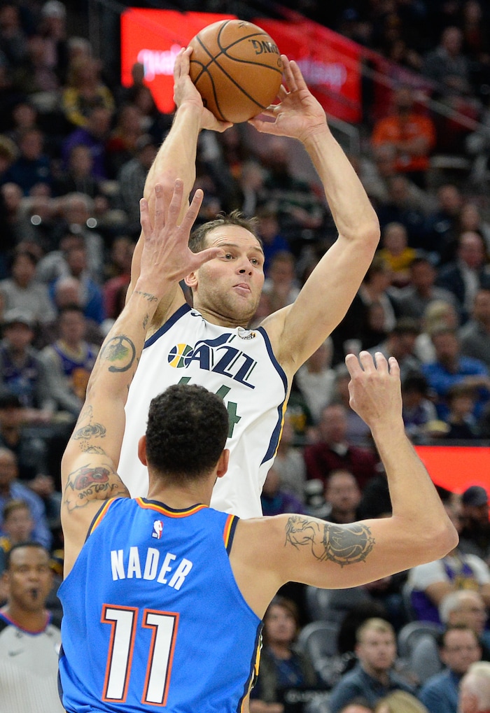 (Francisco Kjolseth  |  The Salt Lake Tribune)  Utah Jazz forward Bojan Bogdanovic (44) looks for an open teammate over Oklahoma City Thunder forward Abdel Nader (11) as the Utah Jazz host the Oklahoma City Thunder in their NBA basketball game at Vivint Smart Home Arena in Salt Lake City on Mon. Dec. 9, 2019.